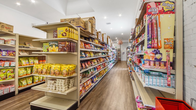 Grocery area. Three aisles of shelving.