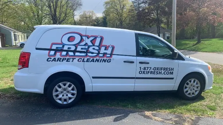 A 2015 Dodge Ram C/V Tradesman Mini Van with Oxi Fresh Logo Wrap