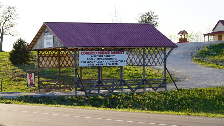 Exterior features attractive covered bridge, drawing in customers from the main highway.