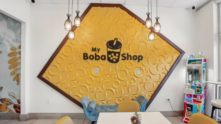 Branded feature wall with signature logo—perfect for photo ops and social media.