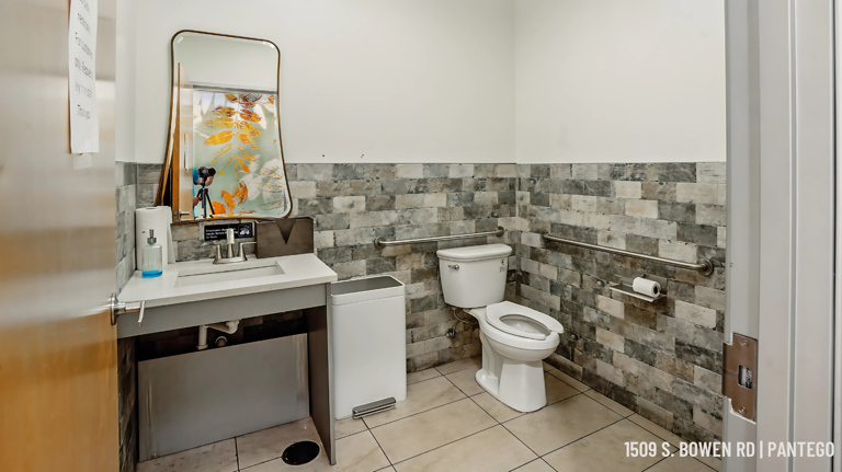 Clean, customer-accessible restroom with modern tile and updated fixtures.