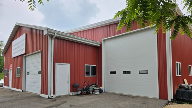 Over-sized garage doors with dedicated wheel alignment bay