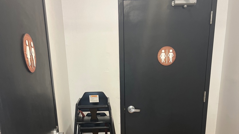 2 restroom with kids changing station in it 