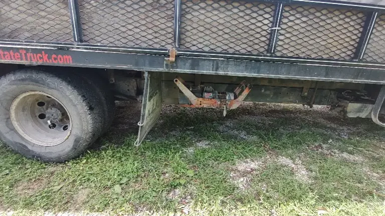 Bed is equipped with a mower retrieval winch that attaches to a hitch on front end of truck bed 