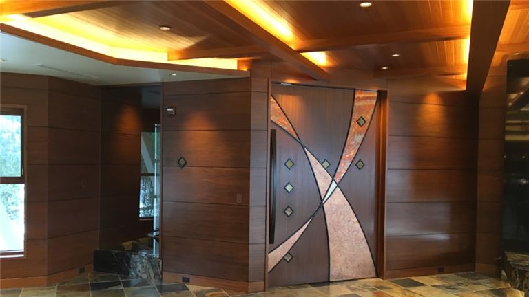 Millworks&amp;#39; custom-designed entry door – showcasing master craftsmanship, precision inlay, and artistic design in high-end residential millwork.