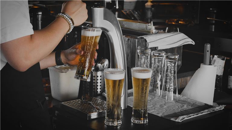 person pouring beer