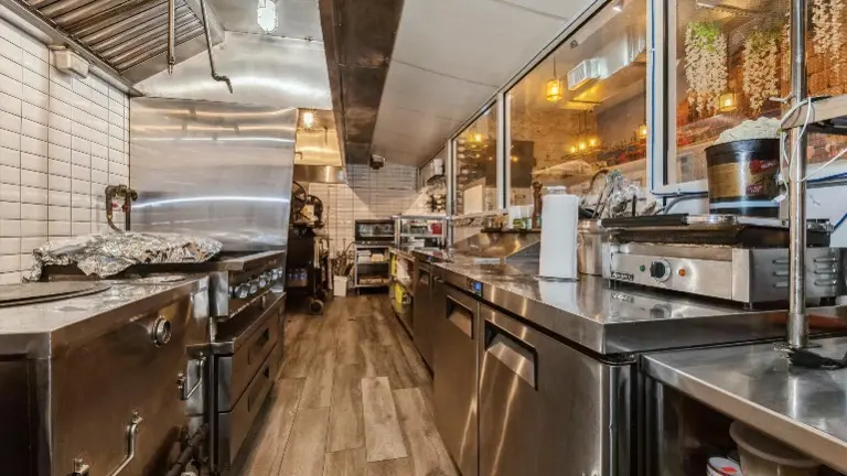 Spacious main Kitchen with stainless steel equipment and ready for service