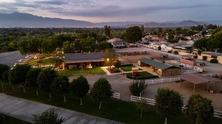 Panoramic twilight aerial of the property’s event center and grounds — a proven income-producing venue with long-term bookings secured.