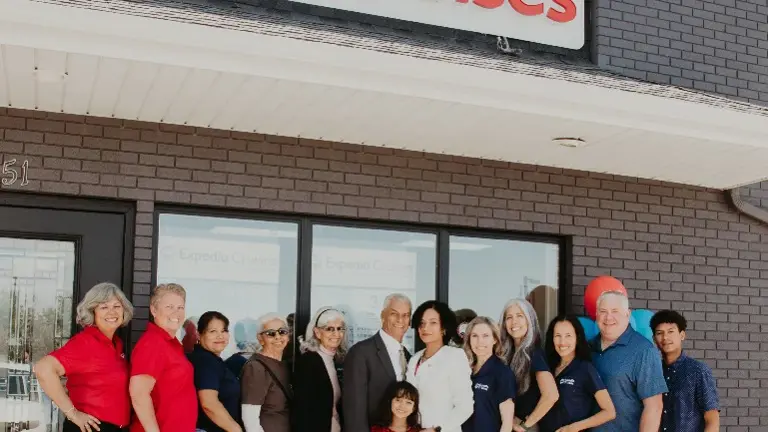 Proud team moment captured outside the renovated Expedia Cruises storefront