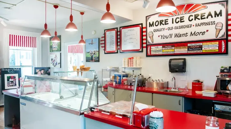 Functional prep area with classic red counters, full equipment, and bright natural light. Functional prep area with classic red counters, full equipment, and bright natural light.