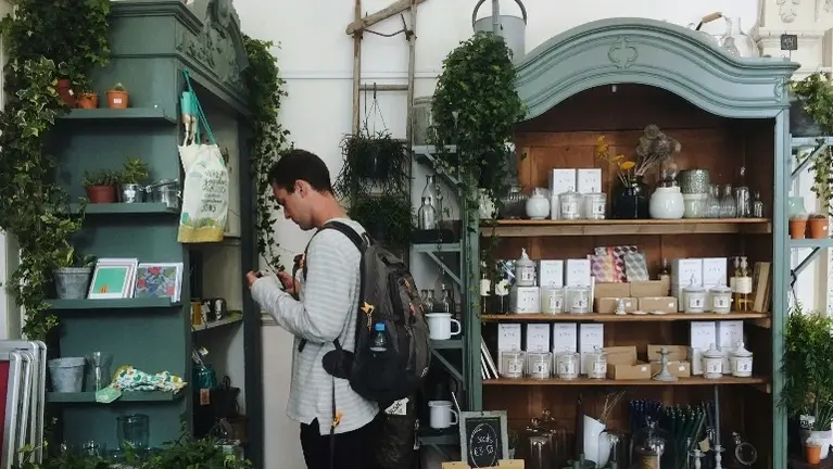 person looking at gifts on shelves person looking at gifts on shelves
