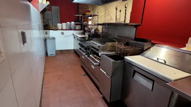 Fully built out kitchen. Deep fryer, 2 ovens, 24 inch griddle, 2 line cook stations and hand wash sink. Fully built out kitchen. Deep fryer, 2 ovens, 24 inch griddle, 2 line cook stations and hand wash sink.