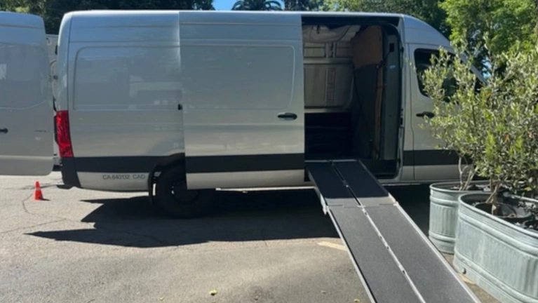 Primary service vehicle — high-roof cargo van with ramp (Mercedes Sprinter class), configured for white-glove logistics Primary service vehicle — high-roof cargo van with ramp (Mercedes Sprinter class), configured for white-glove logistics