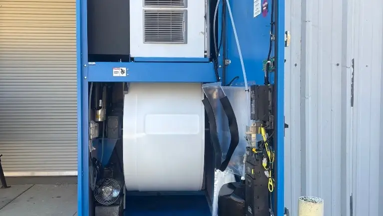 Interior view – filtration, storage barrel, and payment systems in place