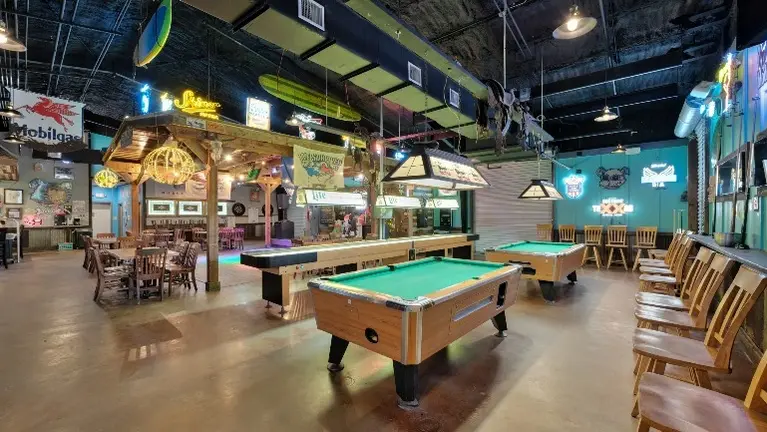 Pool table and shuffle board area. Pool table and shuffle board area.