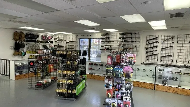 : Professional storefront and well-organized inventory showcasing a wide range of firearms and ammunition. : Professional storefront and well-organized inventory showcasing a wide range of firearms and ammunition.