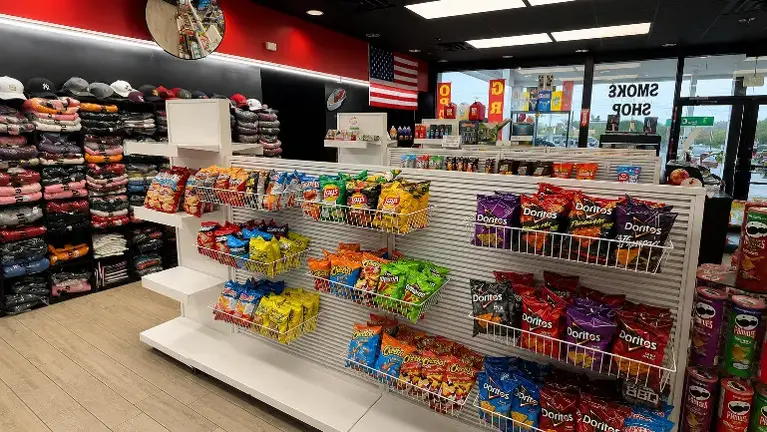 Clean, fully stocked retail floor showcasing premium snack displays, apparel section, and updated fixtures designed to maximize customer traffic and sales.