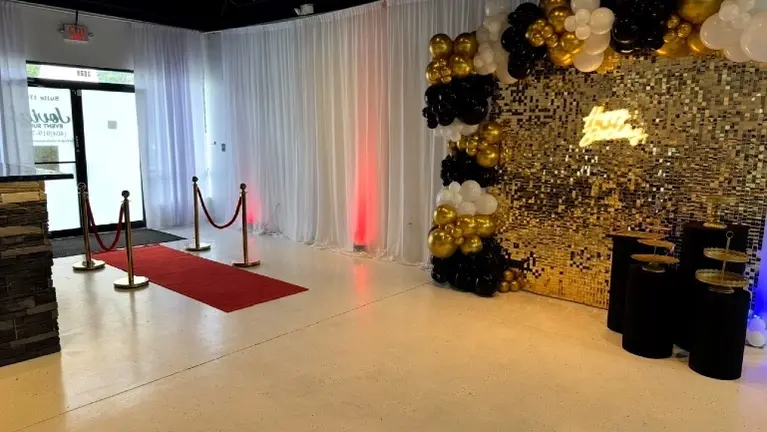 Red carpet entry and photo backdrop area for celebrations.