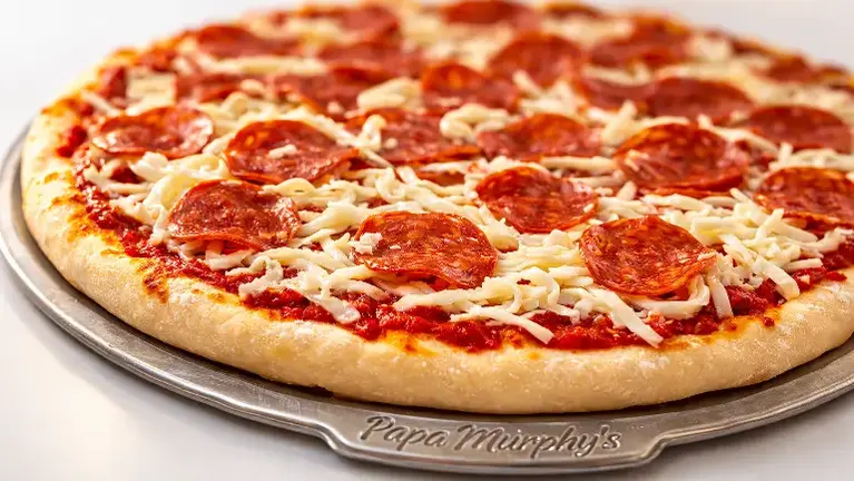 Fresh Take 'N' Bake pizza — scratch-made dough, hand-sliced veggies, freshly grated mozzarella.