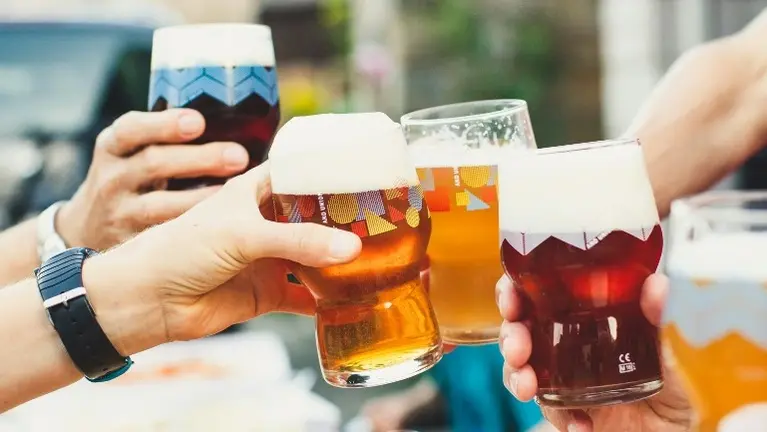 Friends raising a beer toast Friends raising a beer toast