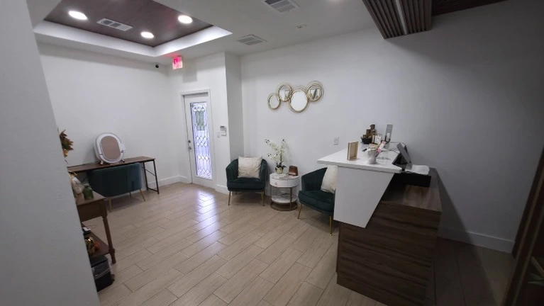 Luxury reception with retail display, Square POS, barcode system, and skin analysis device—fully turnkey operation