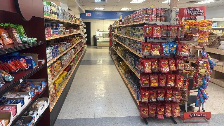 Full aisle view with stocked shelves. All fixtures and inventory included.