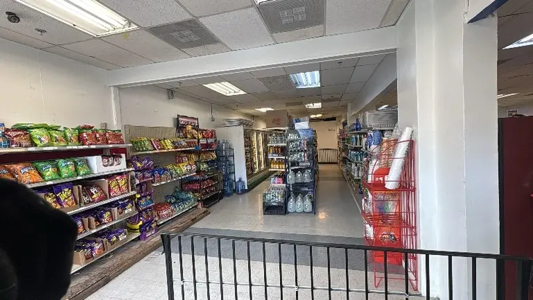  Interior view showing fully stocked gondola shelving and wide aisles.