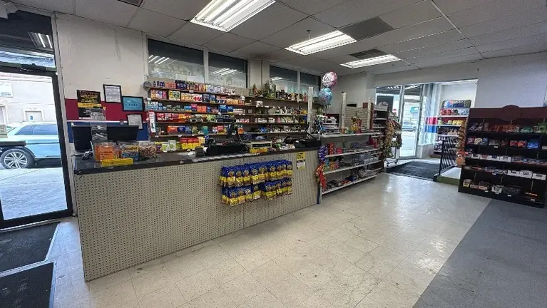 Store interior showing POS area and refrigeration units.