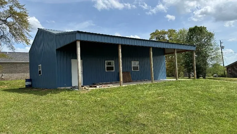 Front of the new shop with mulitple offices inside and a large storage area. 
