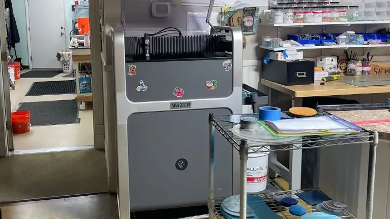 Premium WAZER waterjet cutting system included for precision production.