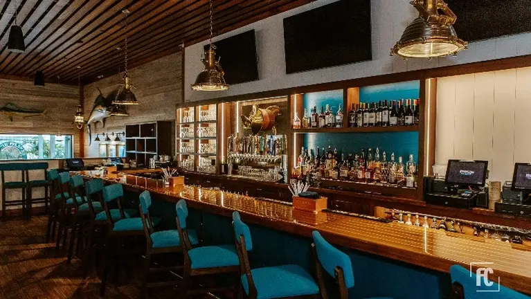 Large Open Bar with 32 Beer Taps and Layered Liquor Shelving with surrounding Bar Seating