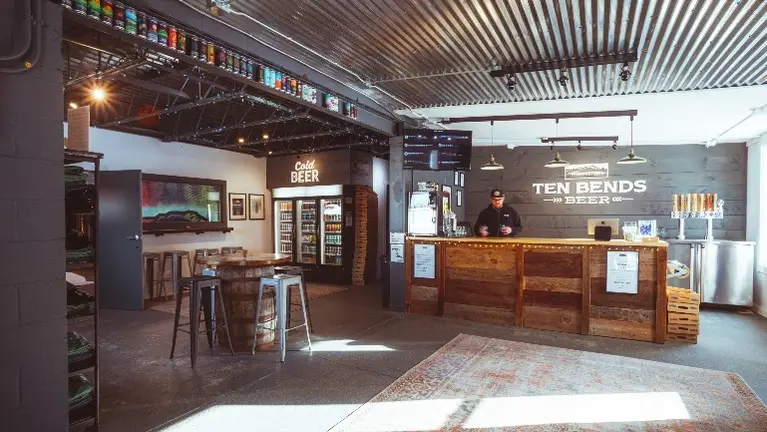 Fully built-out taproom with bar, seating, and retail space, ready for immediate operation.