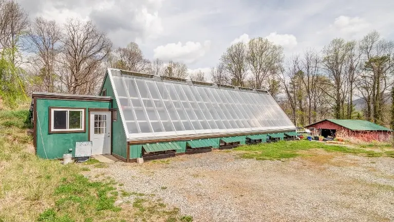 One-of-a-kind passive solar greenhouse produces plants year-round without supplemental heat other than the sun's rays, or cooling other than manual vents.