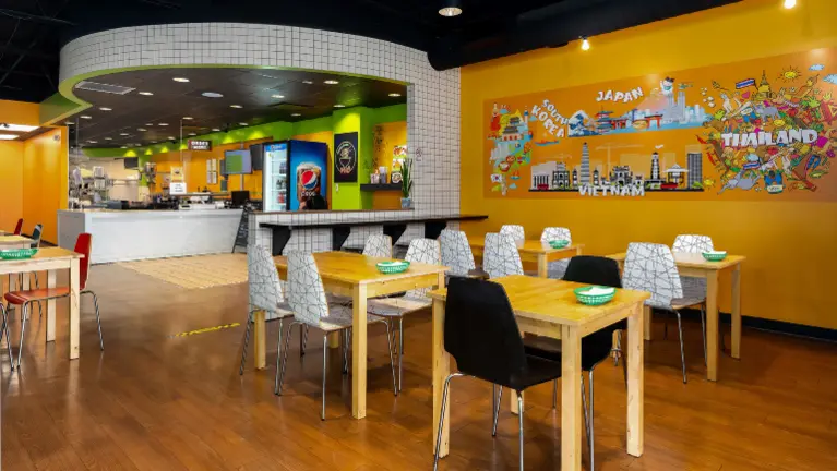 Bright dining area with customer seating, mural wall, and modern Asian fusion interior. Bright dining area with customer seating, mural wall, and modern Asian fusion interior.