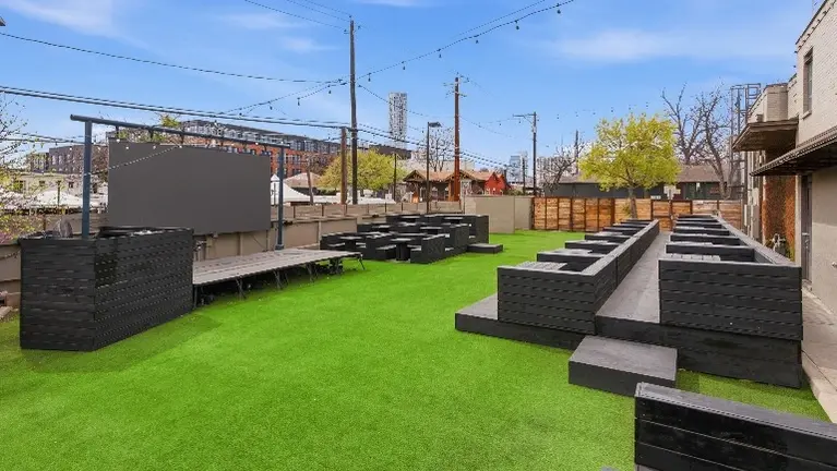 Outside area with seating and large screen perfect for watch parties Outside area with seating and large screen perfect for watch parties