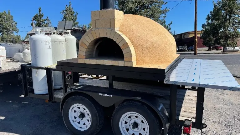 Large pizza oven on steel reinforced trailer. 53 Brick Oven, 5x10, stucco finish, black metal door. With Vamprossa M2 lpg burner with 85k btu capacity Large pizza oven on steel reinforced trailer. 53 Brick Oven, 5x10, stucco finish, black metal door. With Vamprossa M2 lpg burner with 85k btu capacity