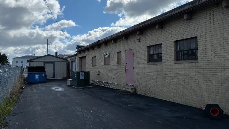 Back of Building with 2 Garages/Shed/Dumpster Back of Building with 2 Garages/Shed/Dumpster
