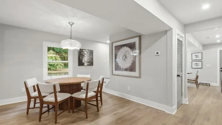 A bright, open living room with a sectional and accent chairs offers guests a relaxed spot to unwind, just steps from the dining area. A bright, open living room with a sectional and accent chairs offers guests a relaxed spot to unwind, just steps from the dining area.