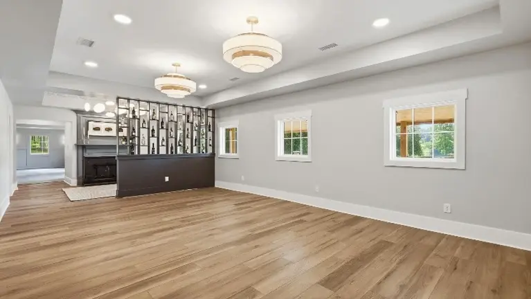 Brushed gold fixtures and a custom wine display wall give the space an elevated, polished feel throughout. Brushed gold fixtures and a custom wine display wall give the space an elevated, polished feel throughout.