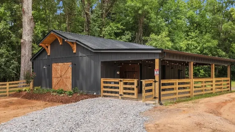 The custom barn offers a versatile space for farm experiences and gatherings, complete with a maintenance shop and stables built right in. The custom barn offers a versatile space for farm experiences and gatherings, complete with a maintenance shop and stables built right in.