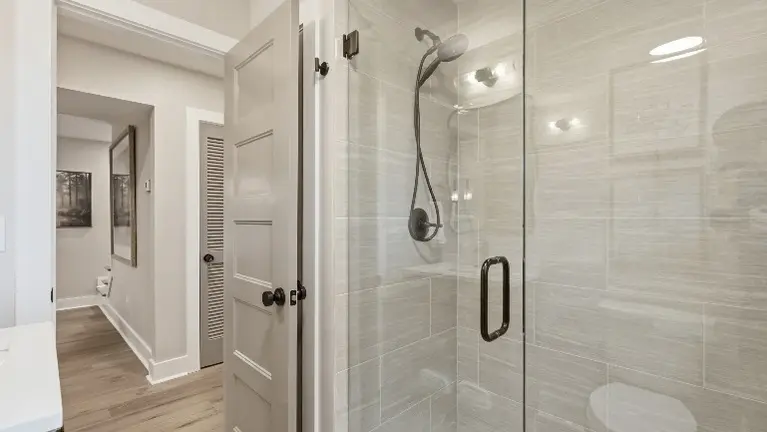 A glass-enclosed walk-in shower gives this bathroom a clean, modern touch. A glass-enclosed walk-in shower gives this bathroom a clean, modern touch.
