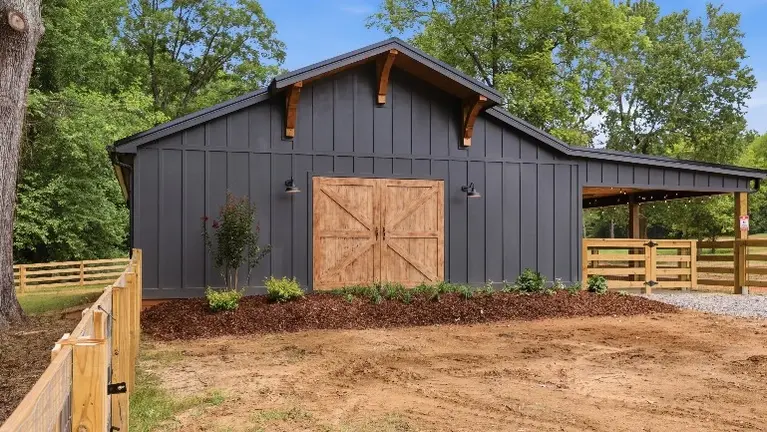 The custom barn offers a versatile space for farm experiences and gatherings, complete with a maintenance shop and stables built right in. The custom barn offers a versatile space for farm experiences and gatherings, complete with a maintenance shop and stables built right in.