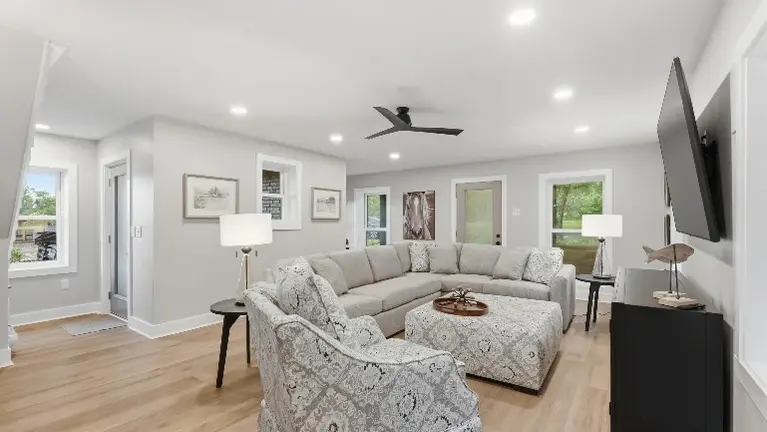 The first floor's main living room offers a spacious, comfortable spot for guests to gather and unwind together. The first floor's main living room offers a spacious, comfortable spot for guests to gather and unwind together.