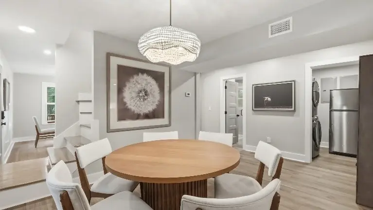 A round dining table sits just off the kitchen, creating an easy, open flow between cooking and gathering spaces. A round dining table sits just off the kitchen, creating an easy, open flow between cooking and gathering spaces.
