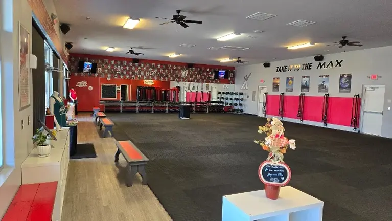 Foyer to front of studio: benches, cubbies, TVs, mirrors, speakers, dumbbells, slam balls (in reflection of mirror:Wavemasters, slam bags and BOSUs) Foyer to front of studio: benches, cubbies, TVs, mirrors, speakers, dumbbells, slam balls (in reflection of mirror:Wavemasters, slam bags and BOSUs)