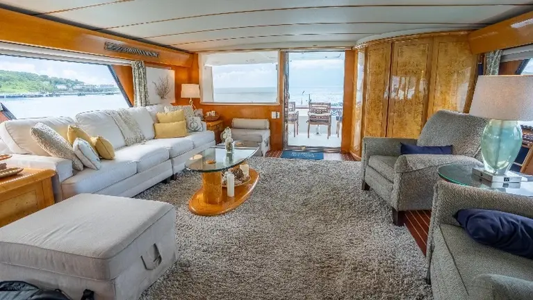 Expansive main salon with panoramic views, elegant seating, and seamless access to the aft deck for indoor-outdoor living. Expansive main salon with panoramic views, elegant seating, and seamless access to the aft deck for indoor-outdoor living.