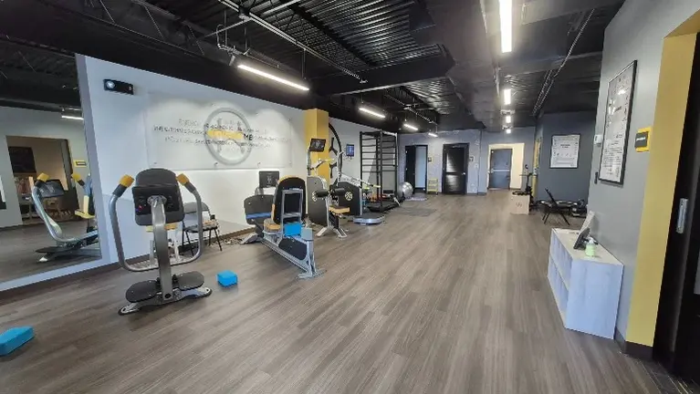 Spacious training area featuring OsteoStrong’s specialized strength and bone health equipment.