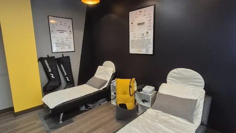 Dedicated recovery area with PEMF mats and NormaTec compression boots, owned outright and included in the sale.