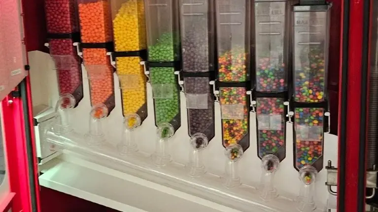 Interior candy hoppers and dispensing assemblies Interior candy hoppers and dispensing assemblies