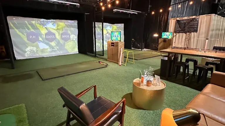 The Golf Lounge featuring two Foresight Sport Falcon overhead monitors